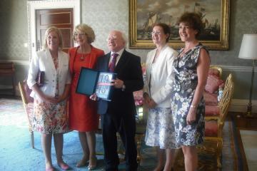 President Michael D. Higgins being presented with copy of book. 