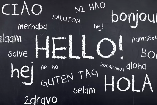 The word 'Hello' written in different languages on a chalkboard