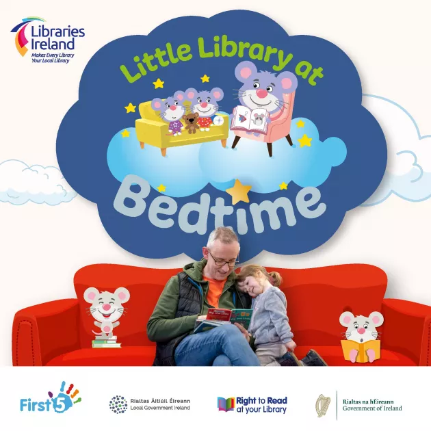 Little Library at Bedtime. Photo of Dad and child reading together on red sofa