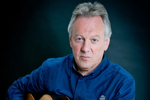 guitarist Luke Tobin seated holding a guitar