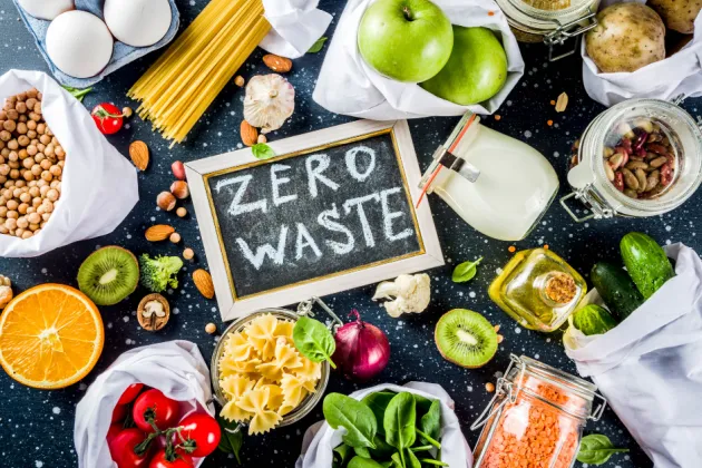 Image of a blackboard with the words 'Zero Waste' written surrounded by fresh fruit and vegetables