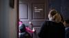 children and teacher walk through georgian door