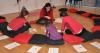 children and teacher sit in circle on floor drawing