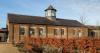 old brick military barracks with lookout tower in autumn