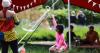 a child blows giant bubbles as mother watches