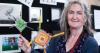 woman holds up hand made saint brigid's cross