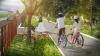 Artist drawing of an adult and a child cycling alongside the santry river.