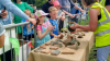 Children gathered around a table with artifacts 