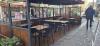 navy tables and chairs surrounding by umbrellas and glass dividers outside Dash Burger on Capel Street