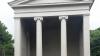 White building with four pillars holding up the structure