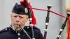 Elderly band member playing the bag pipes