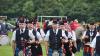 Pipe band in a row of two's in a park