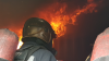 Fire fighters approaching a fire up close 