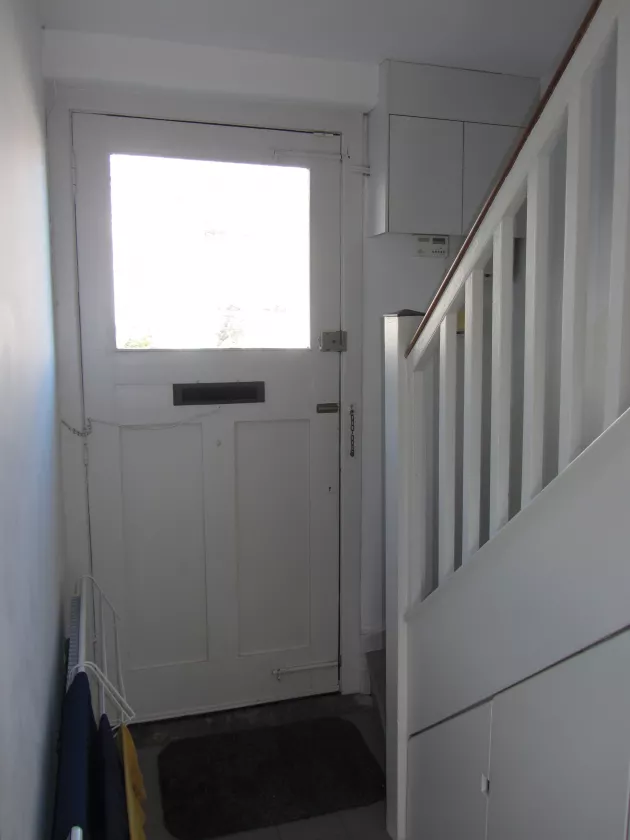 (Clockwise from top left) The unchanged hallway; view in kitchen towards vented fixed light of larder and modern vertical convector heater; vented fixed light; lack of insulation in attic; humidity-triggered extract in bathroom over shower head; the rear door