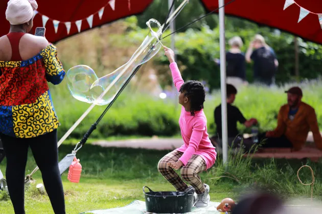 Girl blowing a soap bubble