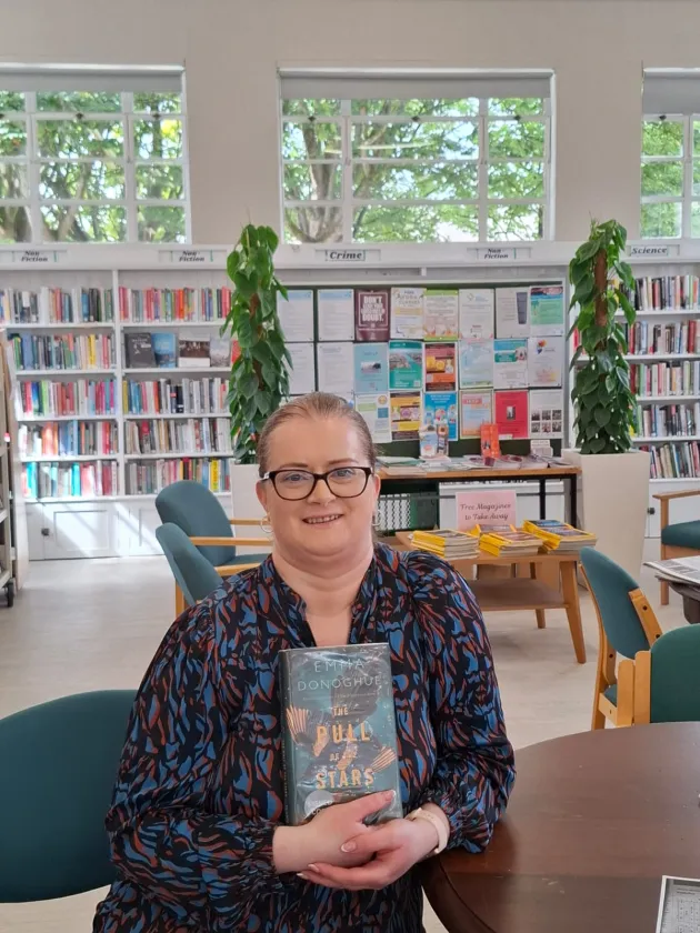 Librarian holding book