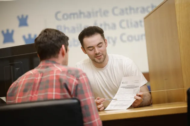 customer service staff sitting at public service counter