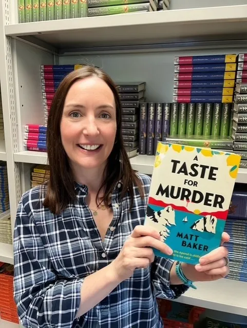 Staff member holding book