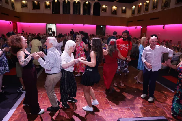 A group of people dance together on stage.