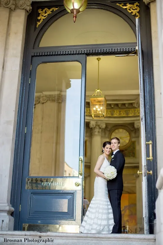 just married couple embracing on city hall steps