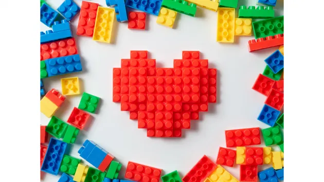 Image of heart shaped lego on white background