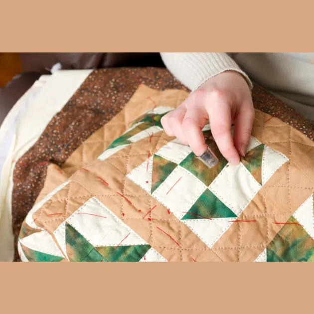 Image of quilt being made by quilters showing their hands