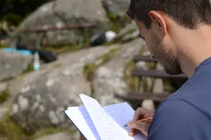 man writing in a notebook