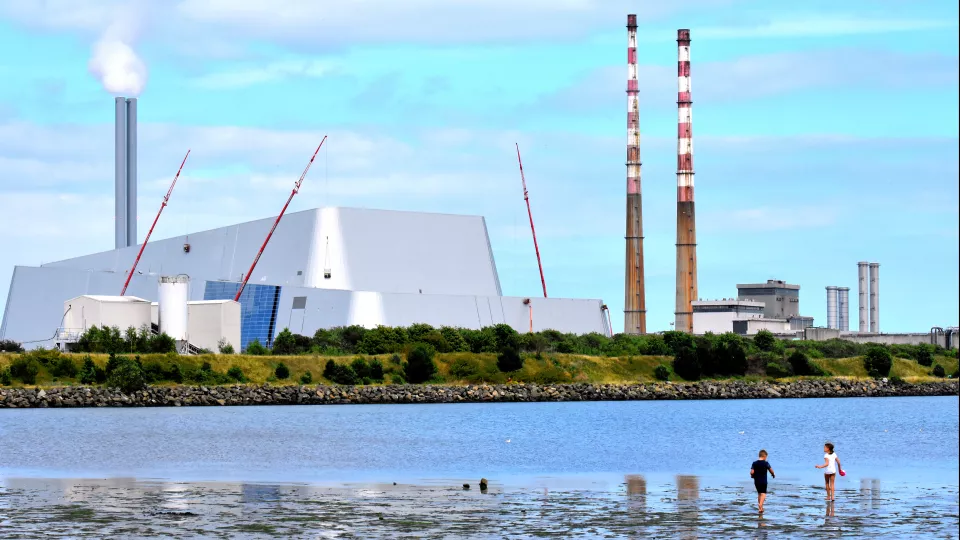 Image of a beach with factories at the back